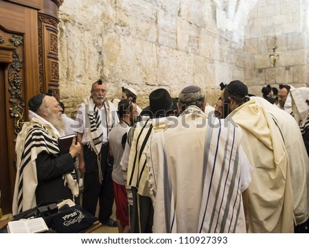 JERUSALEM - JULY 29: Jewish men prays in the Wailing wall during the Jewish holy day of Tisha B\'av, on July 29, 2012 in old Jerusalem, Israel