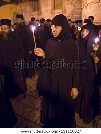 JERUSALEM - AUGUST 25: Unidentified nuns take part in a candle procession as part of the feast of the Assumption of the Virgin Mary on August 25, 2012 in old Jerusalem, Israel