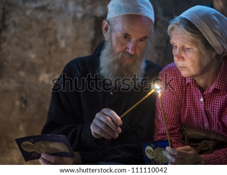 JERUSALEM - AUGUST 25: Unidentified pilgrims prays in the Tomb of Mary in Gethsemane during the feast of the Assumption of the Virgin Mary on August 25, 2012 in old Jerusalem, Israel