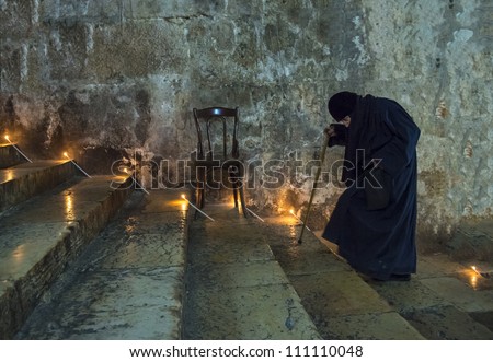 JERUSALEM - AUGUST 25: Unidentified old nun in the Tomb of Mary in Gethsemane during the feast of the Assumption of the Virgin Mary on August 25, 2012 in old Jerusalem, Israel