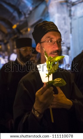 JERUSALEM - AUGUST 25: Unidentified monks take part in a candle procession as part of the feast of the Assumption of the Virgin Mary on August 25, 2012 in old Jerusalem, Israel