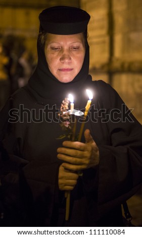 JERUSALEM - AUGUST 25: Unidentified nun take part in a candle procession as part of the feast of the Assumption of the Virgin Mary on August 25, 2012 in old Jerusalem, Israel
