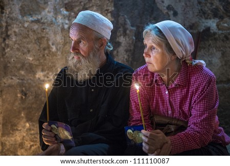 JERUSALEM - AUGUST 25: Unidentified pilgrims prays in the Tomb of Mary in Gethsemane during the feast of the Assumption of the Virgin Mary on August 25, 2012 in old Jerusalem, Israel