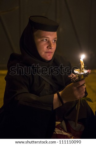 JERUSALEM - AUGUST 25: Unidentified nun take part in a candle procession as part of the feast of the Assumption of the Virgin Mary on August 25,  2012 in old Jerusalem, Israel