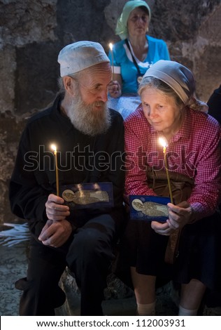 JERUSALEM - AUGUST 25 : Unidentified pilgrims prays in the Tomb of Mary in Gethsemane during the feast of the Assumption of the Virgin Mary on August 25 2012 in old Jerusalem Israel