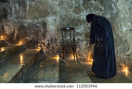 JERUSALEM - AUGUST 25 : Unidentified nun in the Tomb of Mary in Gethsemane during the feast of the Assumption of the Virgin Mary on August 25 2012 in old Jerusalem Israel