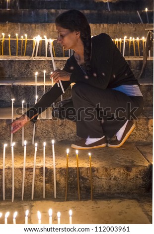 JERUSALEM - AUGUST 25 : Unidentified pilgrim prays in the Tomb of Mary in Gethsemane during the feast of the Assumption of the Virgin Mary on August 25 2012 in old Jerusalem Israel