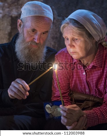 JERUSALEM - AUGUST 25 : Unidentified pilgrims prays in the Tomb of Mary in Gethsemane during the feast of the Assumption of the Virgin Mary on August 25 2012 in old Jerusalem Israel