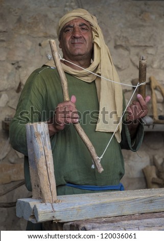NAZARETH, ISRAEL - OCT 15 : Palestinian carpenter work with traditional tools in October 15 2012 at Nazareth Village, historical re-creation of Nazareth as it was at the time of Christ