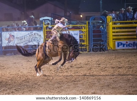 LAS VEGAS - MAY 17 : Cowboy Participant in a Bucking horse Competition at the Helldorado Days Professional Rodeo in Las Vegas , USA on May 17 2013