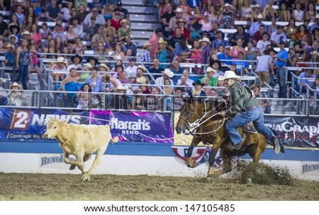RENO , USA - JUNE 30 : Cowboy Participant in a Calf roping Competition at the Reno Rodeo  Professional Rodeo held in Reno Nevada , USA on June 30 2013