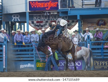 RENO , USA - JUNE 30 : Cowboy Participant in a Bucking Horse Competition at the Reno Rodeo  Professional Rodeo held in Reno Nevada , USA on June 30 2013