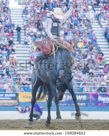 RENO , USA - JUNE 30 : Cowboy Participant in a Bucking Horse Competition at the Reno Rodeo  Professional Rodeo held in Reno Nevada , USA on June 30 2013