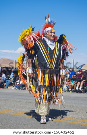 GALLUP , NEW MEXICO - AUGUST 10 : Native American with traditional costume participates at the 92 annual Inter-tribal ceremonial parade on August 10 , 2013 in Gallup New-Mexico