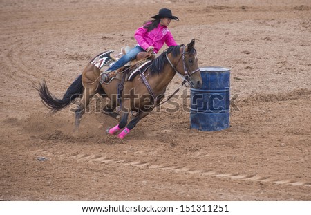 GALLUP , NEW MEXICO - AUGUST 10 : Cowgirl Participant in a Barrel racing competition at the 92nd annual Indian Rodeo in Gallup, NM on August 10 2013