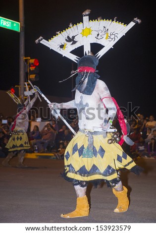 GALLUP , NEW MEXICO - AUG 08 : Apache dancers with traditional costume participates at the annual Inter-tribal ceremonial night parade on August 08 , 2013 in Gallup New-Mexico