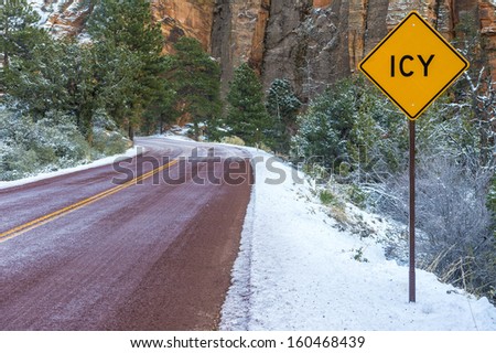 Landscape with road in winter forest and road sign ICY