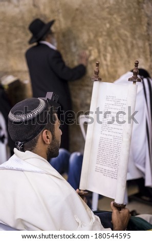 JERUSALEM - JULY 29 : Jewish men prays in the Wailing wall during the Jewish holyday of Tisha B\'av , on July 29 2012 in old Jerusalem , Israel