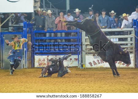LOGANDALE , NEVADA - APRIL 10 : Cowboy Participating in a Bull riding Competition at the Clark County Fair and Rodeo a Professional Rodeo held in Logandale Nevada , USA on April 10 2014