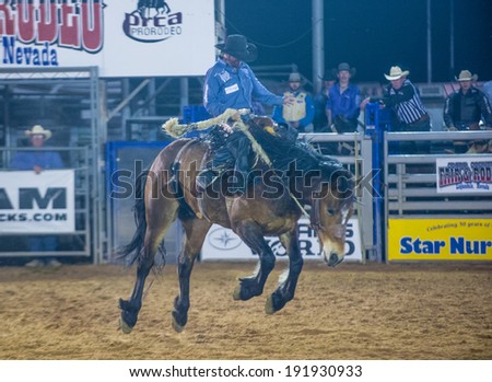LOGANDALE , NEVADA - APRIL 10 : Cowboy Participating in a Bucking Horse Competition at the Clark County Fair and Rodeo a Professional Rodeo held in Logandale Nevada , USA on April 10 2014