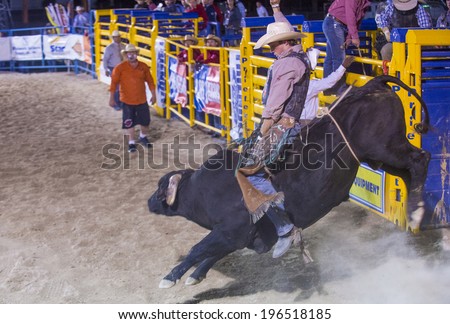 LAS VEGAS - MAY 16 : Cowboy Participating in a Bull riding Competition at the Helldorado days Rodeo , A professional Rodeo held in Las Vegas on May 16 , 2014
