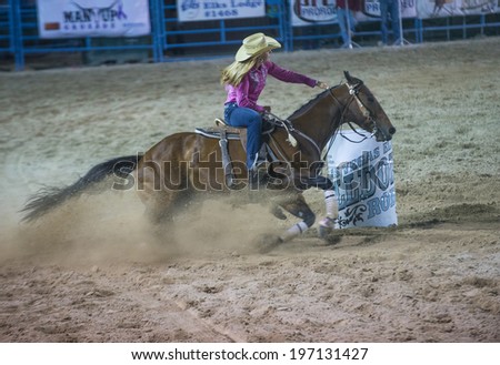 LAS VEGAS - MAY 16 : Cowgirl Participating in a Barrel racing competition at the Helldorado Days Rodeo , A professional rodeo held in Las Vegas , Nevada on May 16 2014