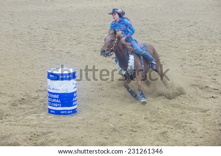 LAS VEGAS - NOV 05 : Cowgirl Participating in a Barrel racing competition at the Indian national finals rodeo held in Las Vegas , Nevada on November 05 2014