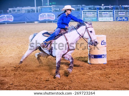 LOGANDALE , NEVADA - APRIL 10 : Cowgirl Participating in a Barrel racing competition in the Clark County Fair and Rodeo a Professional Rodeo held in Logandale Nevada , USA on April 10 2015