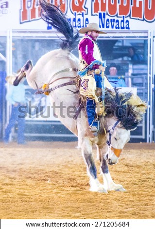 LOGANDALE , NEVADA - APRIL 10 : Cowboy Participating in a Bucking Horse Competition at the Clark County Fair and Rodeo a Professional Rodeo held in Logandale Nevada , USA on April 10 2015