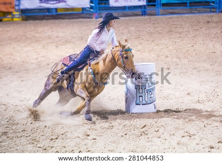 LAS VEGAS - MAY 16 : Cowgirl Participating in a Barrel racing competition at the Helldorado Days Rodeo , A professional rodeo held in Las Vegas , Nevada on May 16 2015