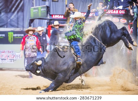 LAS VEGAS - MAY 23 : Cowboy Participating in a Bull riding Competition at the Las Cowboy Standing , a cometition with the fifty of the top bull riders in the world held in Las Vegas on May 23 , 2015