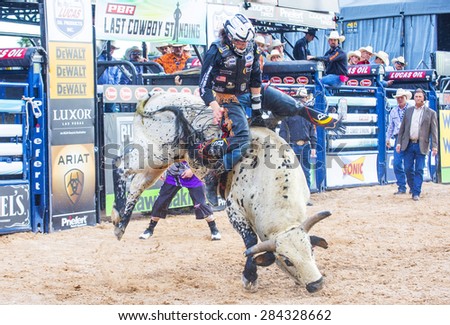 LAS VEGAS - MAY 23 : Cowboy Participating in a Bull riding Competition at the Las Cowboy Standing , a PBR cometition with the fifty of the top bull riders in the world held in Las Vegas on May 23 2015