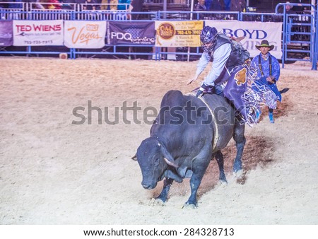 LAS VEGAS - MAY 16 : Cowboy Participating in a Bull riding Competition at the Helldorado days Rodeo , A professional Rodeo held in Las Vegas , Nevada on May 16 , 2015