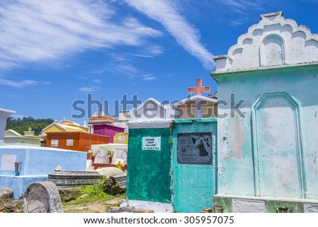 CHICHICASTENANGO , GUATEMALA - JULY 26 : Colorful Cemetery in Chichicastenango on July 26 2015. in Guatemala family members paint the tombstone as a way of honoring the dead