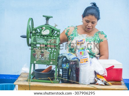 CHICHICASTENANGO , GUATEMALA - JULY 26 : Guatemalan woman sells shaved ice in the Chichicastenango Market on July 26 2015. This native market is the most colorful in Central America
