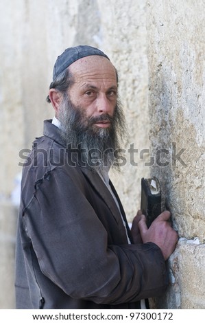 JERUSALEM - FEB 05 : Orthodox jewish man prays in The western wall on February 05 2011. The Western wall is important Jewish religious site located in the Old City of Jerusalem , Israel