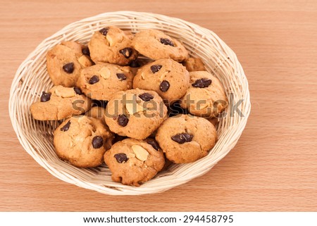 Cookies in basket on wooden ground