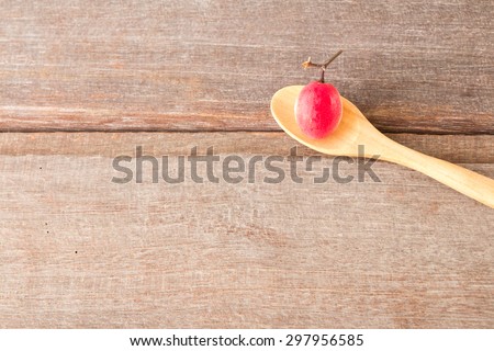Carissa carandas fruits in wood spoon on wood background