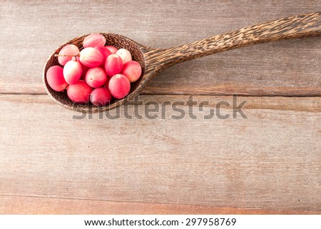 Carissa carandas fruits in wood spoon on wood background