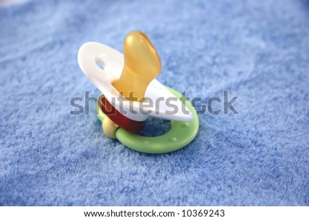 pacifier on a blue baby blanket