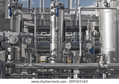 Close up of a modern natural gas processing plant with pressure dials on gasworks pipes