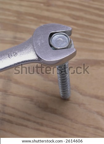 Open ended Wrench tightening bolt in wood