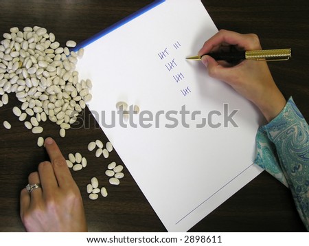 Accountant or book keeper counting beans and marking tally