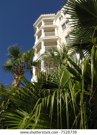 Vacation Resort Building Towers and Palm Tree