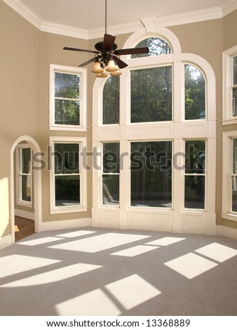 Luxury Model Home Living Room with Arched Window Wall