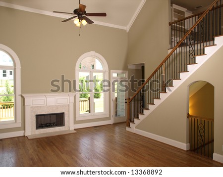 Luxury Model Home Living Room with fireplace and staircase