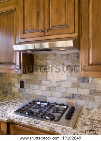 Kitchen cooktop and cabinets angle view