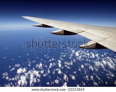 Scattered Cloud pattern with Airplane wing over ocean