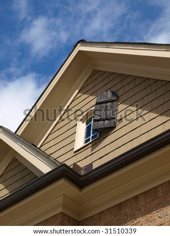 Luxury Model Home Exterior with attic window close up