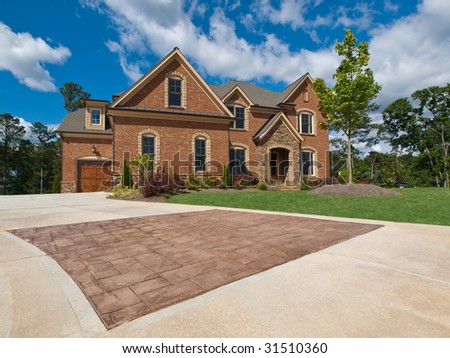 Luxury Model Home Exterior with stone driveway horizontal